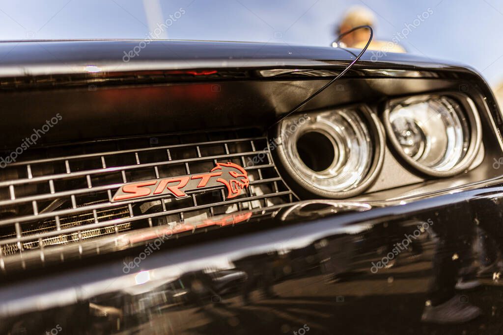 Rome, italy 4 may 2025: close-up of dodge challenger srt front grill and headlight, showcasing power and performance