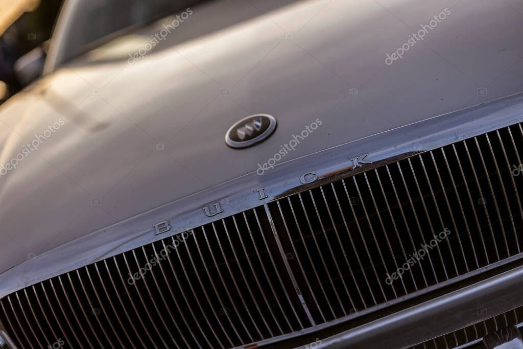 Rome, italy 4 may 2025: close-up of buick logo and grille, reflecting sunlight on a polished car hood