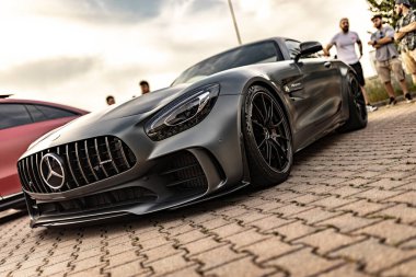 Milan, İtalya, 4 Haziran 2025, bir Mercedes Amg GT 'nin dar açılı görüntüsü, bir tuğla yola park edilmiş, parlak tasarımı ve güçlü varlığı sergileniyor.
