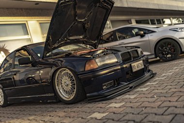 Milan, İtalya 4 Haziran 2025, özelleştirilmiş bmw e36 açık kaputlu, motor modifikasyonları bir araba buluşmasında sergileniyor