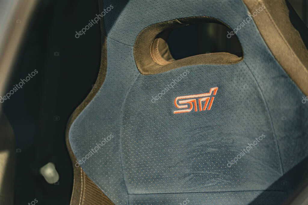 Milan, italy 4 june 2025, empty blue bucket seat with orange sti logo, belonging to a tuned subaru impreza wrx