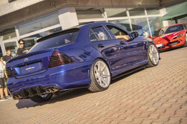 Roma, İtalya 18 Temmuz 2025, mavi Mercedes Benz sınıfı w203 akortlu bir tuğla kaldırıma park edilmiştir.