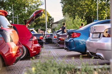 Roma, İtalya, 18 Temmuz 2025, gayri resmi bir akort toplantısı sırasında arka arkaya park edilmiş özel arabalar, açık bagaj ve mekanik tartışmaları