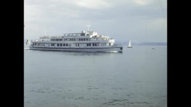Stuttgrat, Almanya Mayıs 1975, turistler göl kıyısındaki feribotta manzaralı bir gemi yolculuğunun keyfini çıkarıyorlar. Arka planda büyüleyici Meersburg kasabası var.