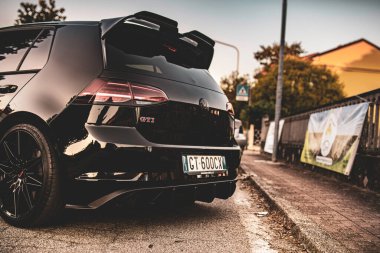 Calaone, İtalya 13 Ağustos 2025: modern akortlu Volkswagen golf gti kaldırıma park edilmiş bir banliyö yolunun yanında.