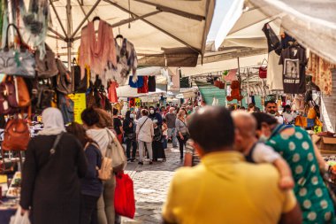 Bolonya, İtalya 19 Ağustos 2025: Koruyucu yüz maskesi takan müşteriler Bolonya, İtalya 'da bir açık hava pazarında yürüyor ve alışveriş yapıyorlar.