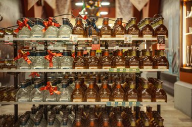 Tulum, Meksika 20 Ağustos 2025: Granan Centenario tekila şişeleri, kırmızı kurdelelerle süslenmiş, Tulum, Meksika 'da bir mağazada rafları dolduruyor.