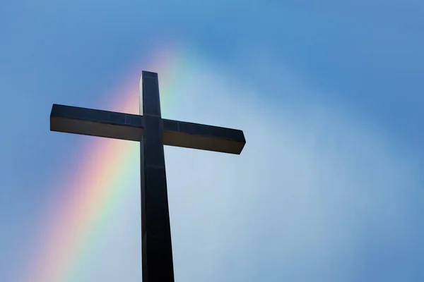 Rainbow and religious cross symbol of Christianity
