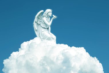 Angel on white cloud against blue clear sky with copy space