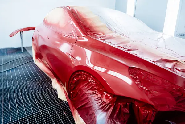 Red color freshly painted car service center auto repair body paint workshop auto service.
