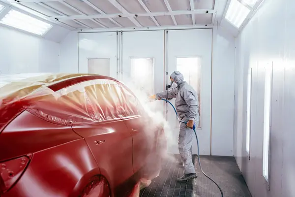 专业汽车维修工在专业汽车维修服务的喷涂间内喷涂汽车 — 图库照片