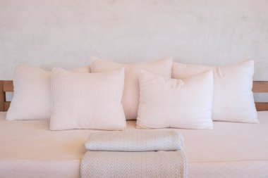 five pillows on brown sofa