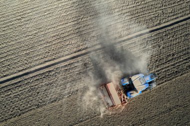 Bir traktörün açık kırsala buğday ekmeden önceki halinin havadan çekilmiş belgesi. 