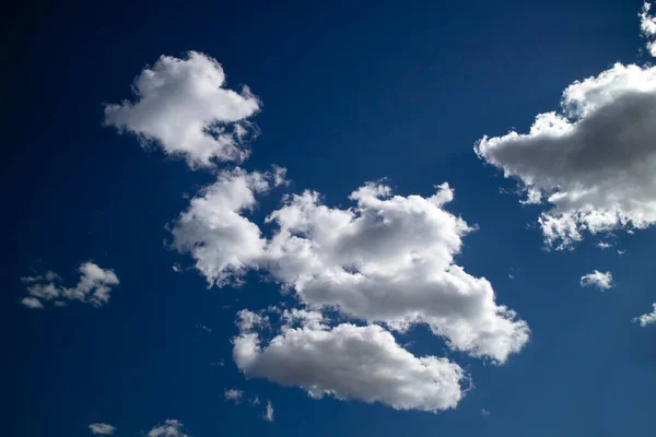 Photographic documentation of the passage of a group of clouds in a blue sky