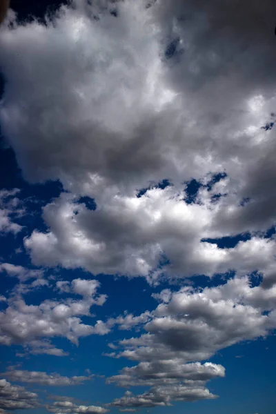 Photographic documentation of the passage of a group of clouds in a blue sky