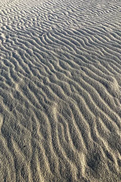 Photographic documentation of the sand smoothed and drawn by the strong wind