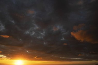 Gün batımı evresinde kara bulutların fotoğraflı belgesi 