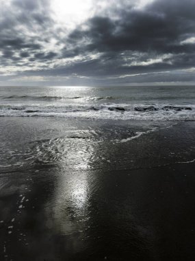 Photographic documentation of the arrival of black clouds in the pre-storm phase over the sea 