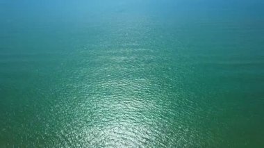 Deniz şeffaflığı ve doğal ışığın iyi, sakin ve hipnotik kum üzerinde altın yansımalarıyla harmanlandığı bir video.. 