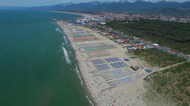 Viareggio sahilinin renkli şemsiyelerle donatılmış havadan çekilmiş video görüntüleri, canlı yaz atmosferi.. 