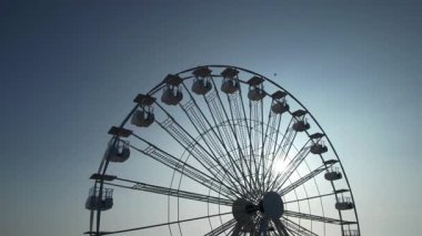 Yazın ve turizmin sembolü Lido di Camaiore, Versilia Tuscany 'de gün batımında gökyüzüne karşı çağrıştıran dönme dolap.. 