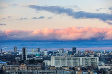 Colorful sky and clouds at sunset and twilight against the background of the urban evening landscape.