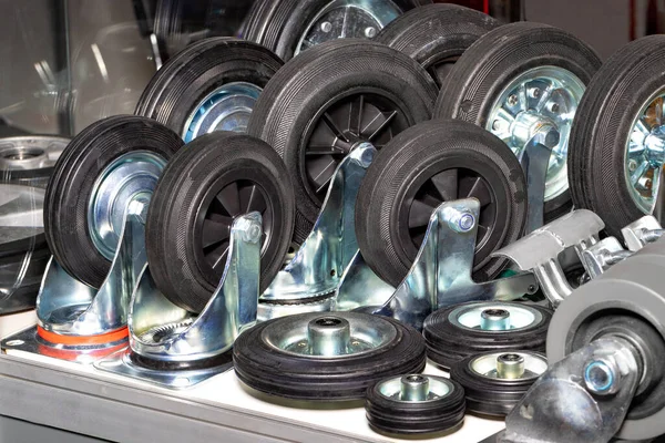 Group of industrial wheels in different sizes in black for use in heavy industrial trolleys.