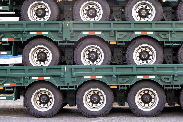 Close-up of wheeled trailer platforms stacked on top of each other for trucks. Copy space.