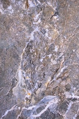 Stone granite surface with an abstract pattern in section. Beautiful background close up. Vertical image.