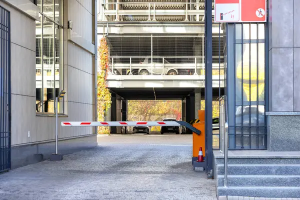 An automatic barrier at the entrance to a multi-storey car park.