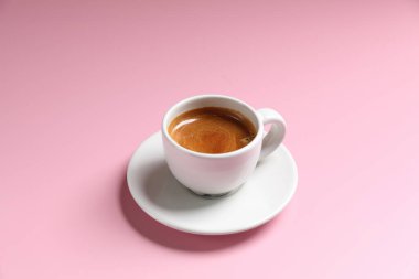 Pembe arka planda beyaz kahve espresso.