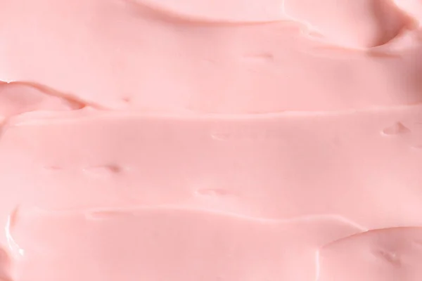 Pink skin care cosmetic beauty cream texture background in close up