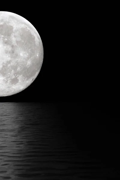 stock image Moon at night in the black sky. The reflection of moonlight in the water