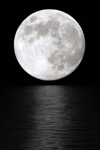 Moon at night in the black sky. The reflection of moonlight in the water