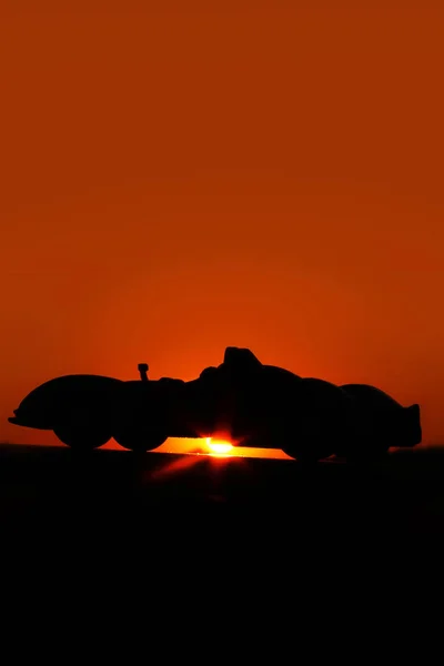 Silhouette car. Car on a sunset background. Beautiful landscape. Car in the shade