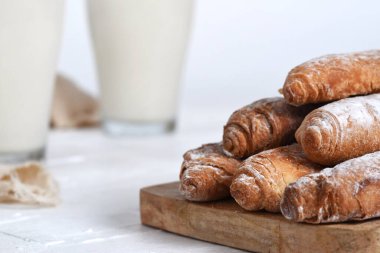 Fartones ayık una tabla de madera, acompaada de horchata de chufa servida en vasos de cristal. İdeal para ilustrar la gastronoma valenciana, nafaka geleneksel.