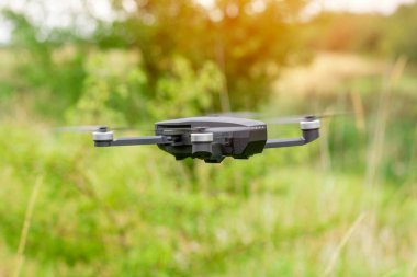 man using a drone with remote controller  making photos and videos,  having fun with new  technology trends