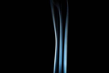 incense stick with white smoke against black background