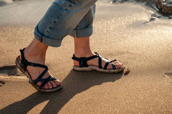 Close up of woman feet walking  on seaside . Vacation, travel and freedom concept. People relaxing in summer.