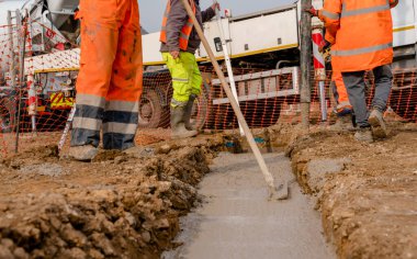 İnşaat alanında taşınabilir beton pompa. İnşaatçılar ev temellerini ıslak hazır betonla dökerler.