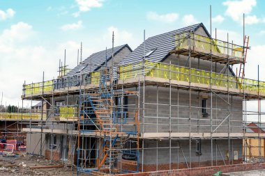 Scaffolding erected around houses in a new housing development