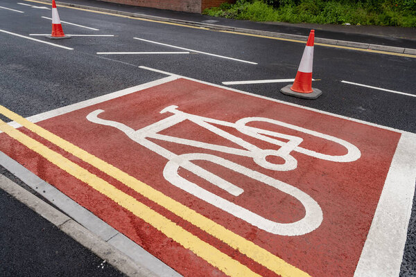 New cycling path made of red asphalt as part of 10 minutes city development plan.