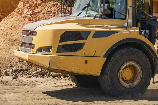 Close-up of the big yellow articulated dump truck earth mover