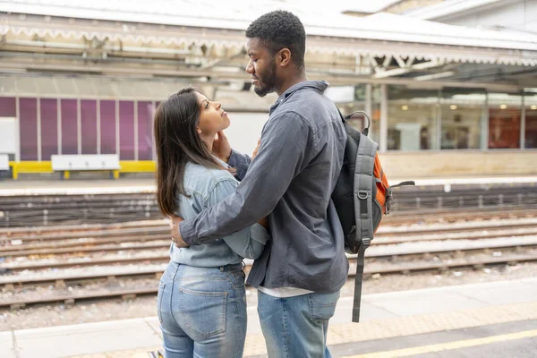 a young beautiful couple embraces on the platform meeting, saying goodbye the spouse, friend. Travel lifestyle concept
