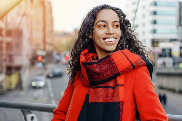 Şehrin sokaklarında yürüyen ve güneşli günlerin tadını çıkaran çekici genç bir kadının yüz resmi.