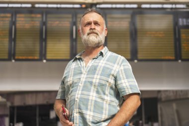 Mutsuz sakallı adam tren istasyonlarında grev olduğu için geç kaldı ve treni kaçırdı.