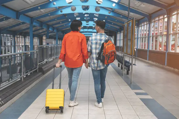 a young couple traveling together with luggage in interchange. Traveling together concept