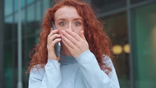 赤毛の女性は 電話を使って 唇に指を入れた 静かなリップサイレンスサイン ジェスチャーのサインじゃない 口を閉じるコンセプト — ストック動画