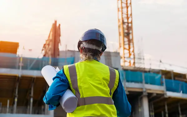 stock image Female site engineer surveyor working with theodolite total station EDM equipment on a building construction site outdoors