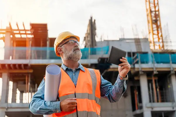 stock image Surveyor builder site engineer with theodolite total station at construction site outdoors during surveying work